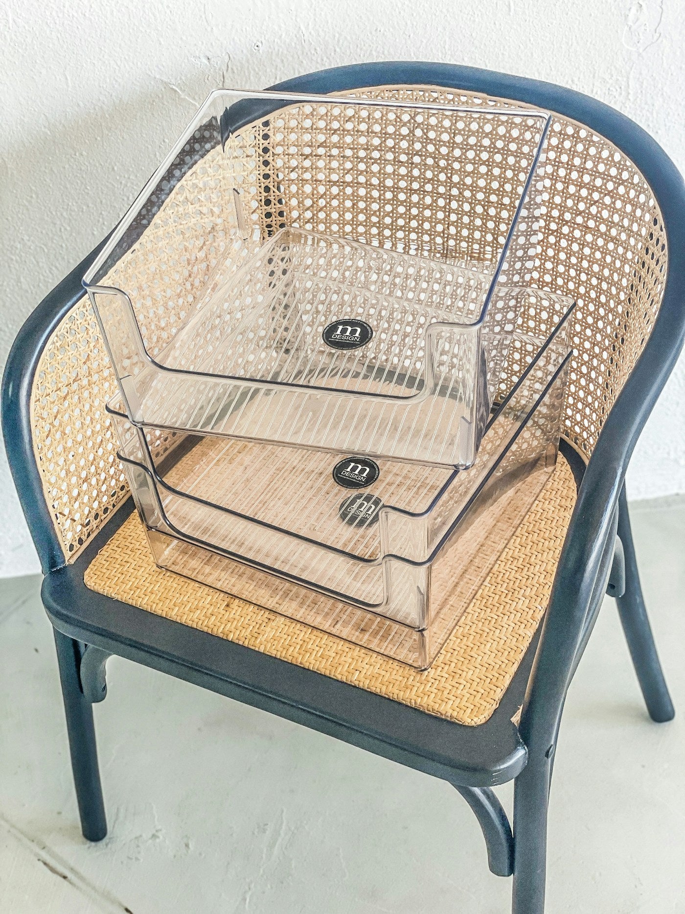 Two clear stackable home organization bins